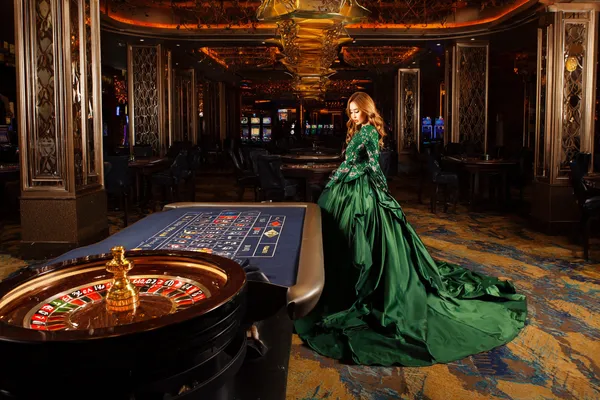 A young woman relaxing with her phone while dynamic casino elements float around her, illustrating the smooth mobile experience offered by the 0777DET app.