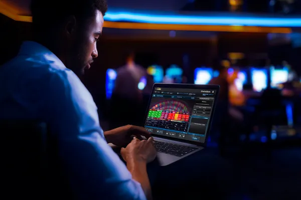 0777DET Casino Games — Enjoy nonstop entertainment A close-up shot of golden coins falling around a spinning roulette wheel, representing immersive casino action at 0777DET.