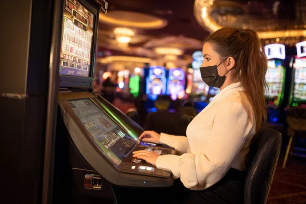 A player using their smartphone during a festive local event, representing 0777DET’s fully mobile-friendly casino.